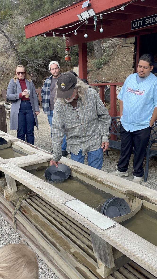 Guide demonstrating gold panning technique at Eagle Mine Julian