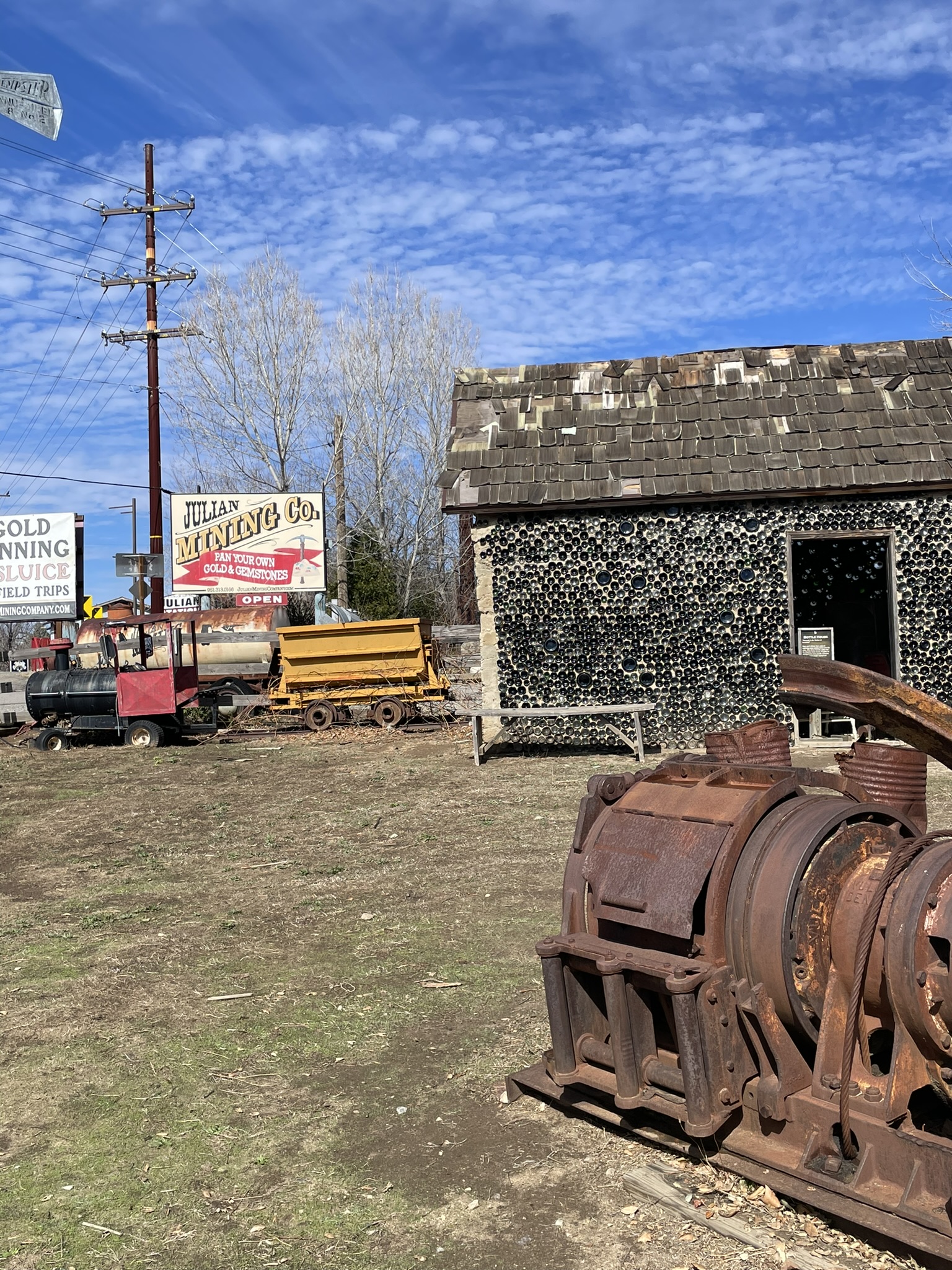 Rustic exterior of Julian Mining Company with old equipment
