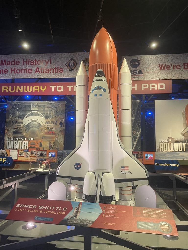 A 1/15 scale model of the Space Shuttle attached to its orange external tank and white boosters, in the 'Runway to the Launch Pad' exhibit at Kennedy Space Center