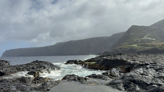 Waves crashing on the volcanic rocky coast at Ponta da Ferraria, Azores