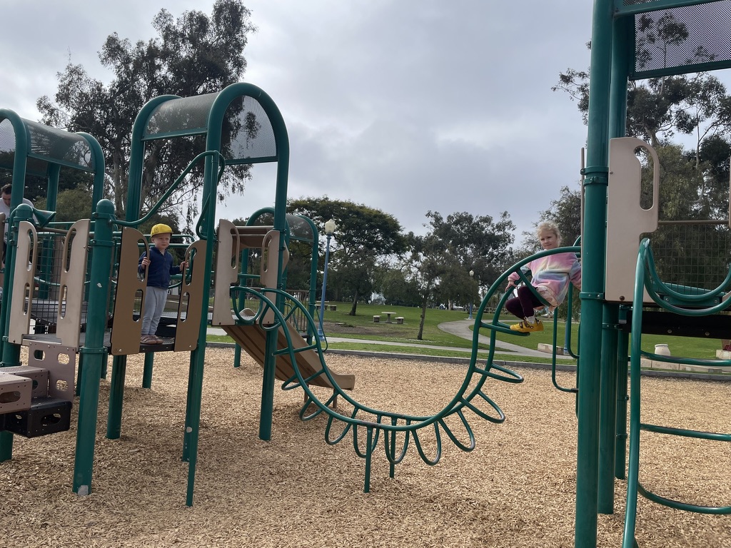 Two children playing on the outdoor playground equipment at Balboa Park