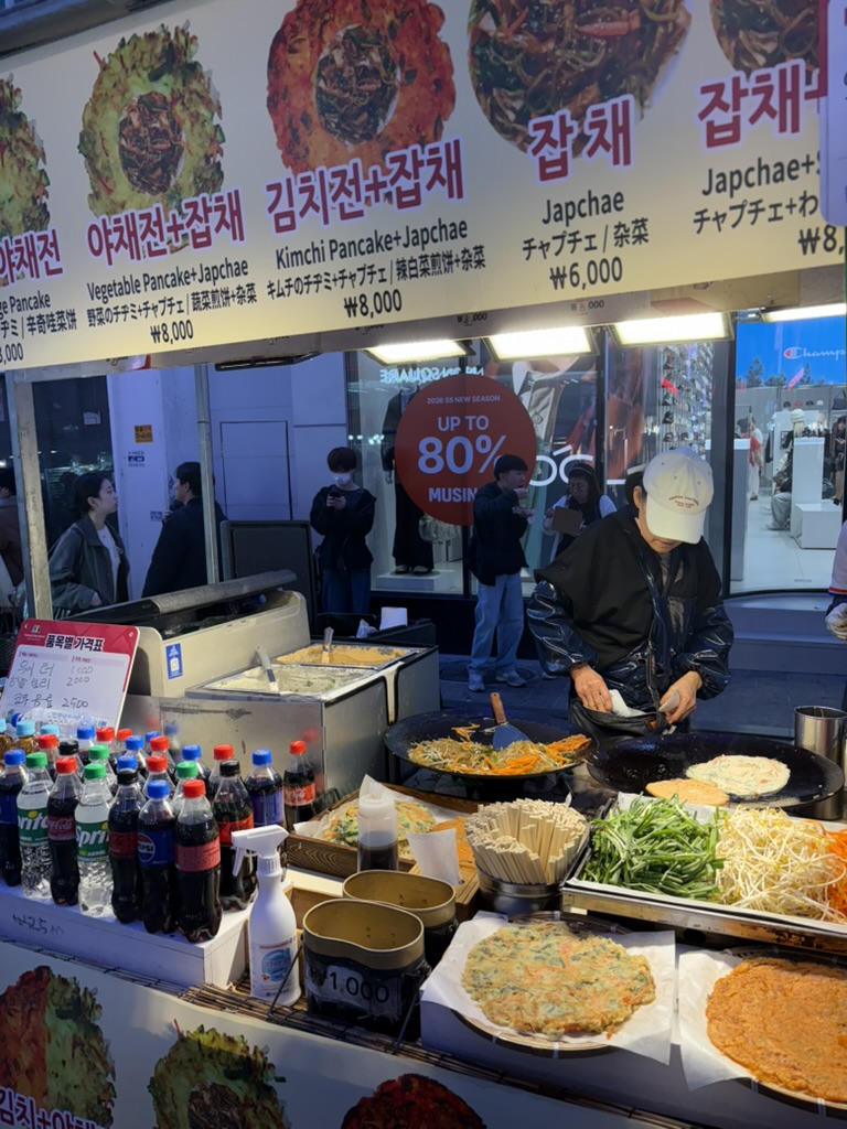 Street food stall in Myeongdong serving pajeon and japchae