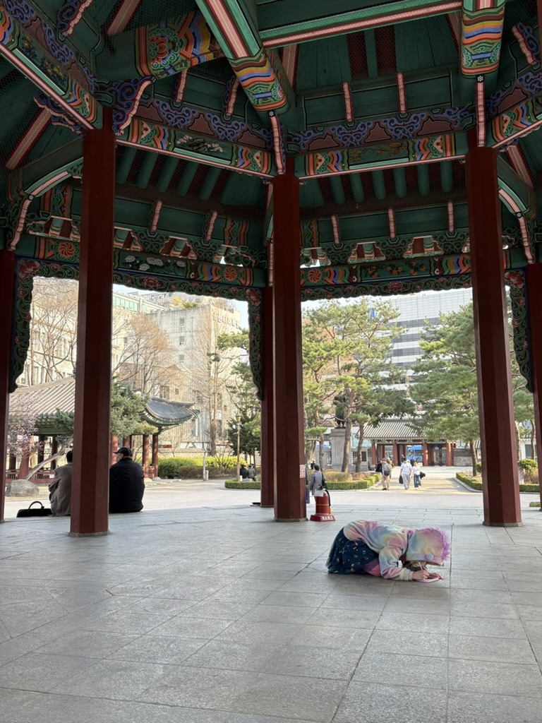 Child exploring the pavilion at Tapgol Park, Seoul