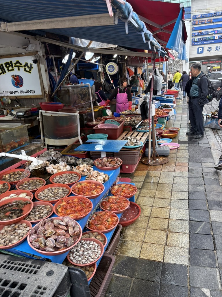 Seafood stalls at Jagalchi Market with shellfish and clams in bowls, Busan